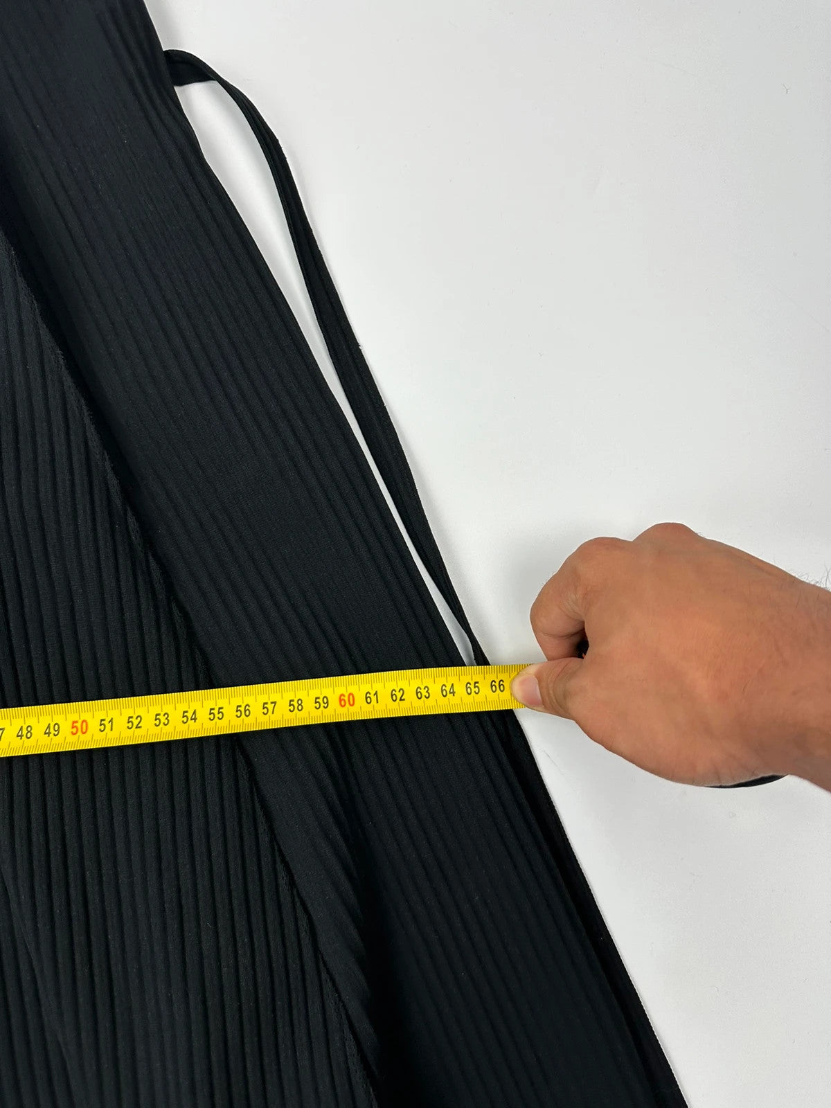 Issey Miyake black linen maxi dress with pleated design and unique string details.