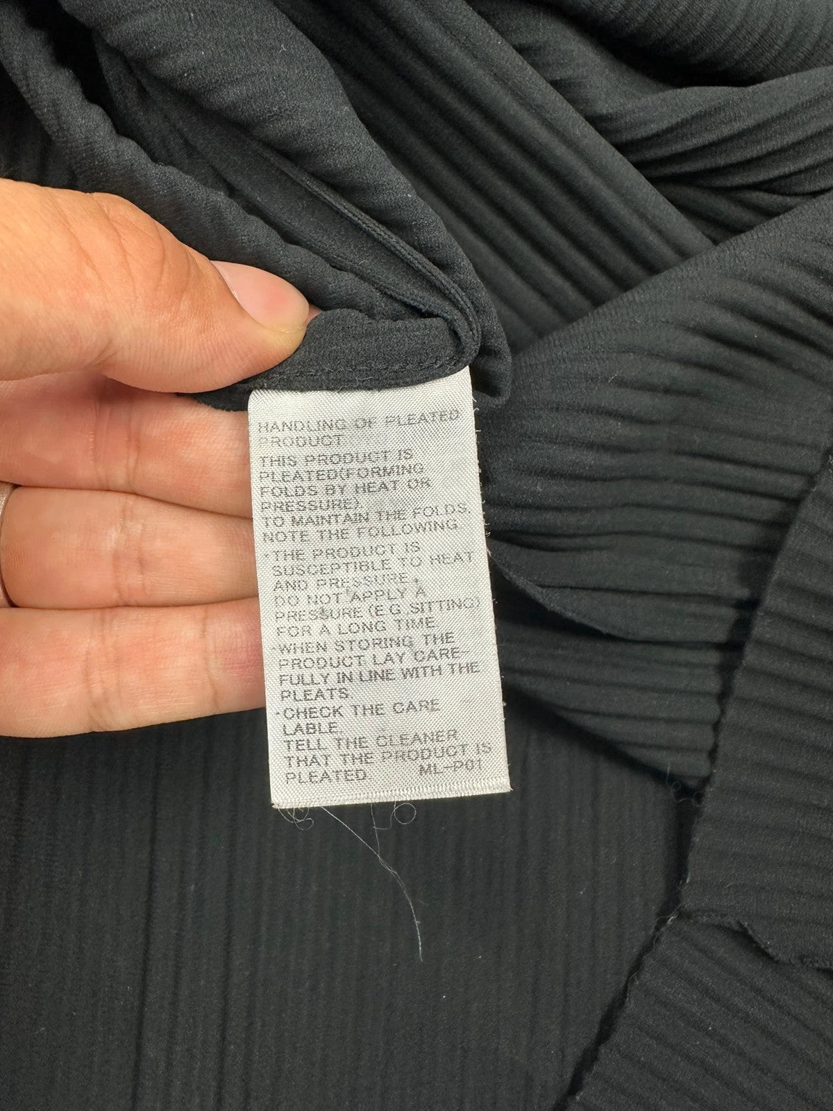 Issey Miyake black linen maxi dress with pleated design and unique string details.
