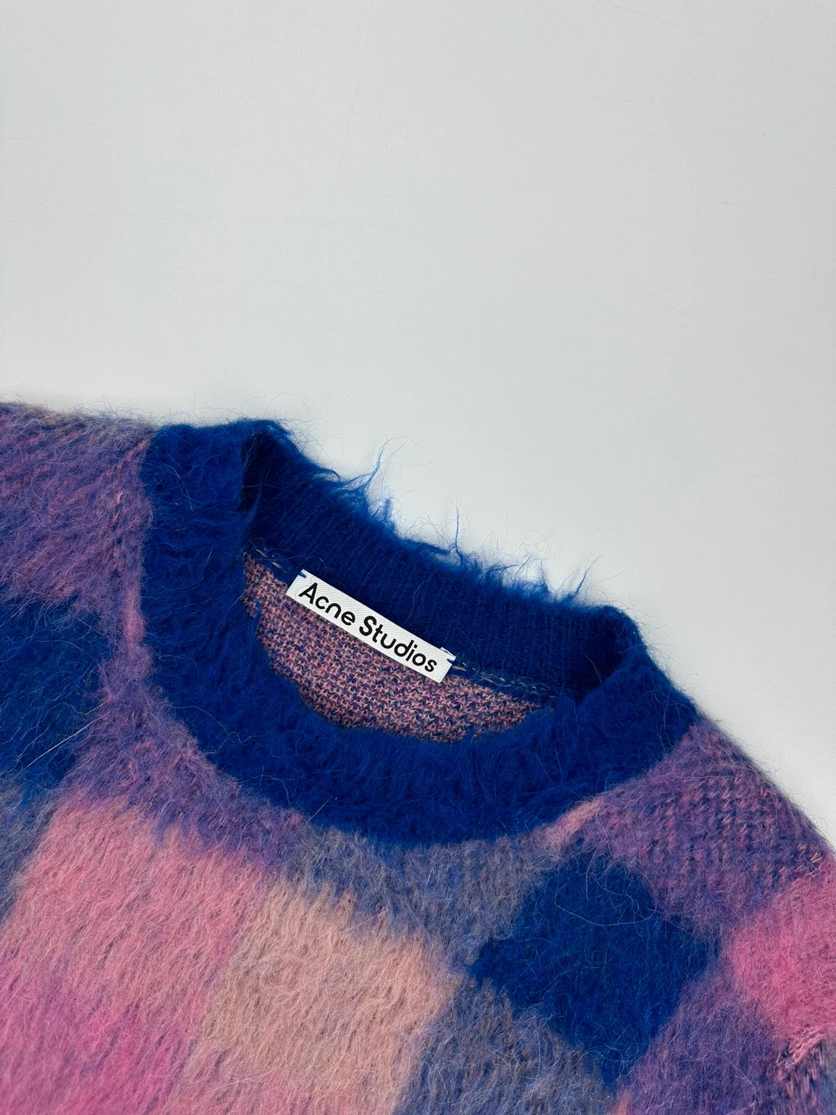 Acne Studios multicolor alpaca wool knit sweater with fuzzy texture and unique patterns.