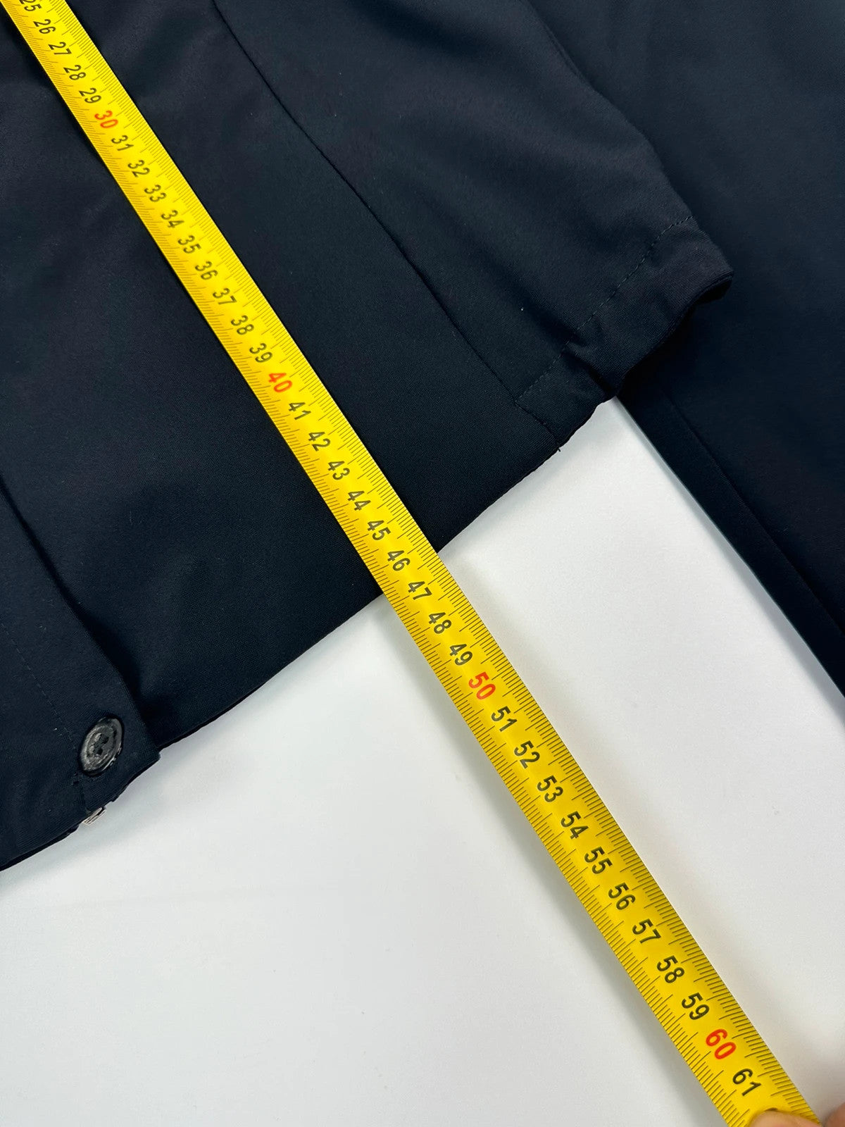 Marithé Francois Girbaud navy crop jacket with V-neck and minimalist design.