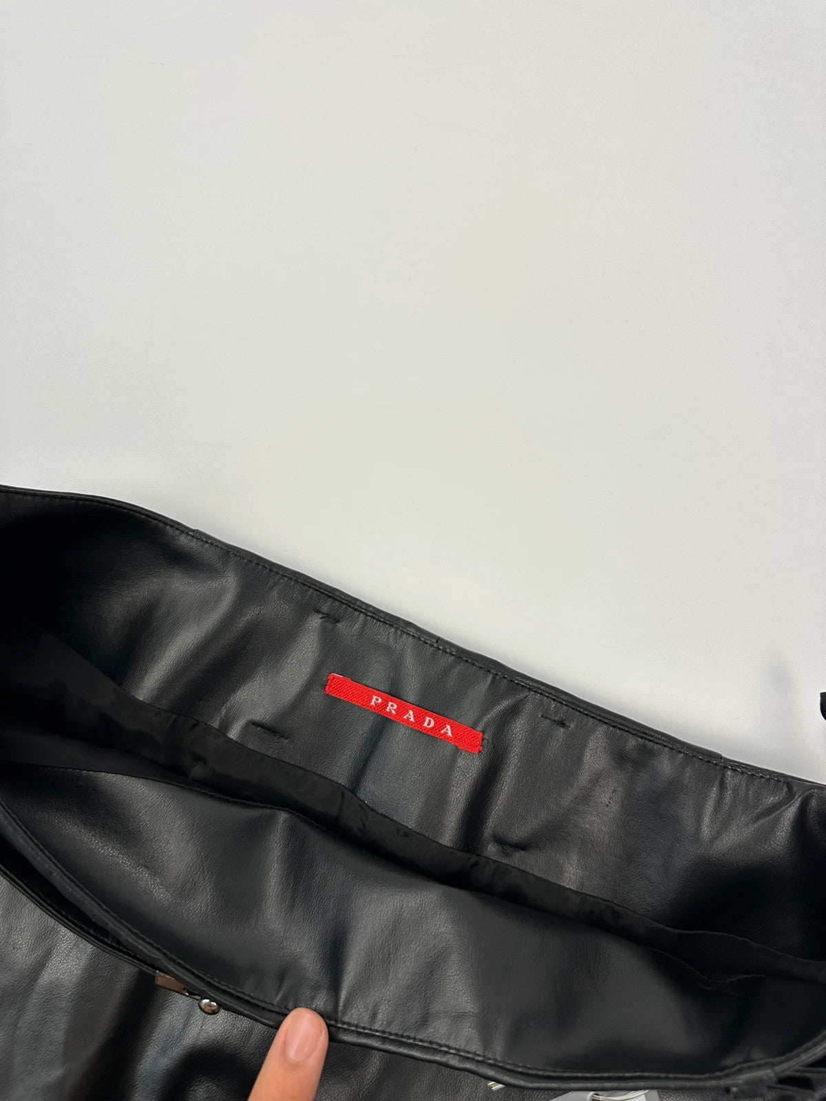 Prada black shiny mini skirt with logo waistband from SS2008 collection.