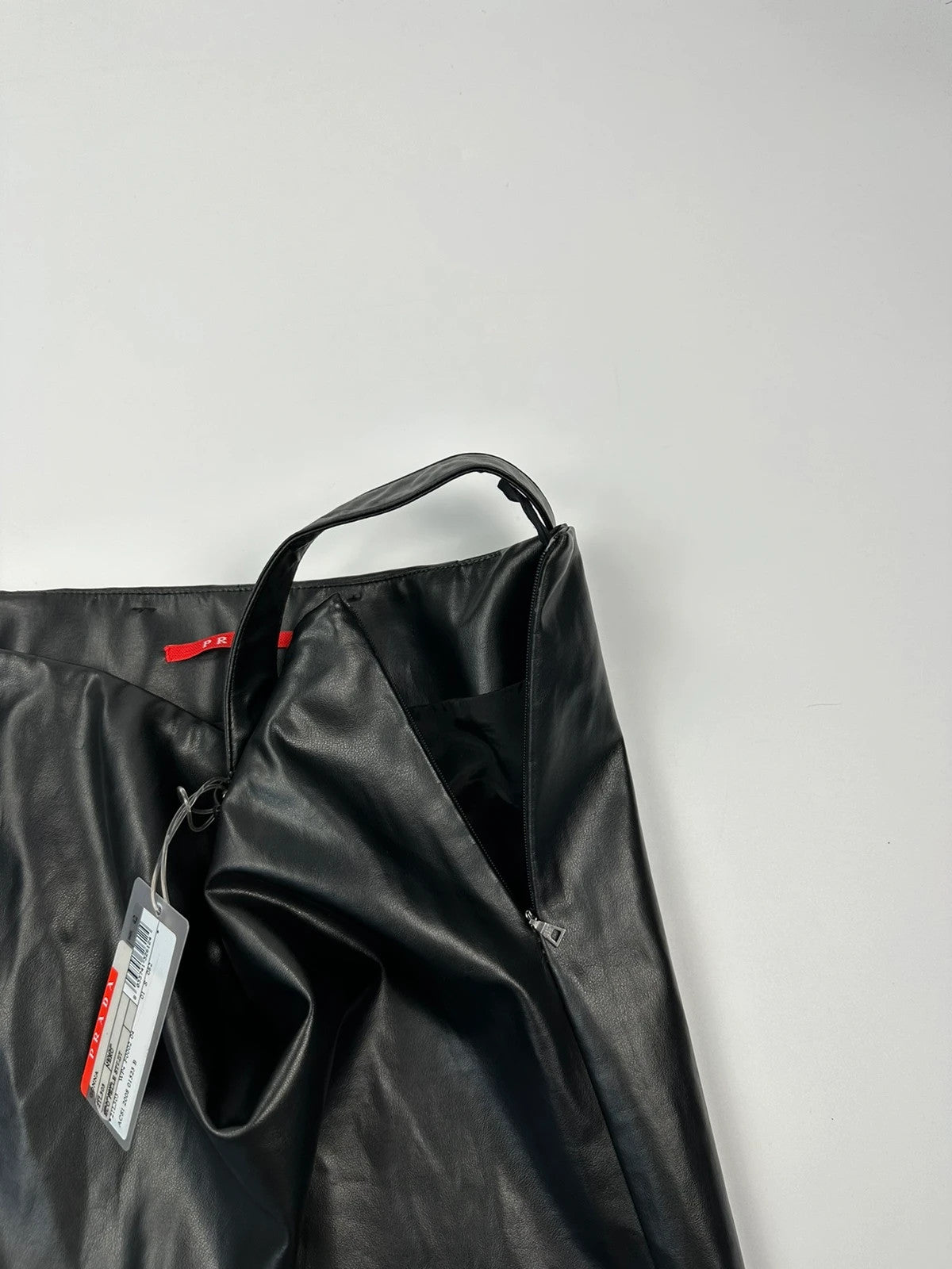 Prada black shiny mini skirt with logo waistband from SS2008 collection.