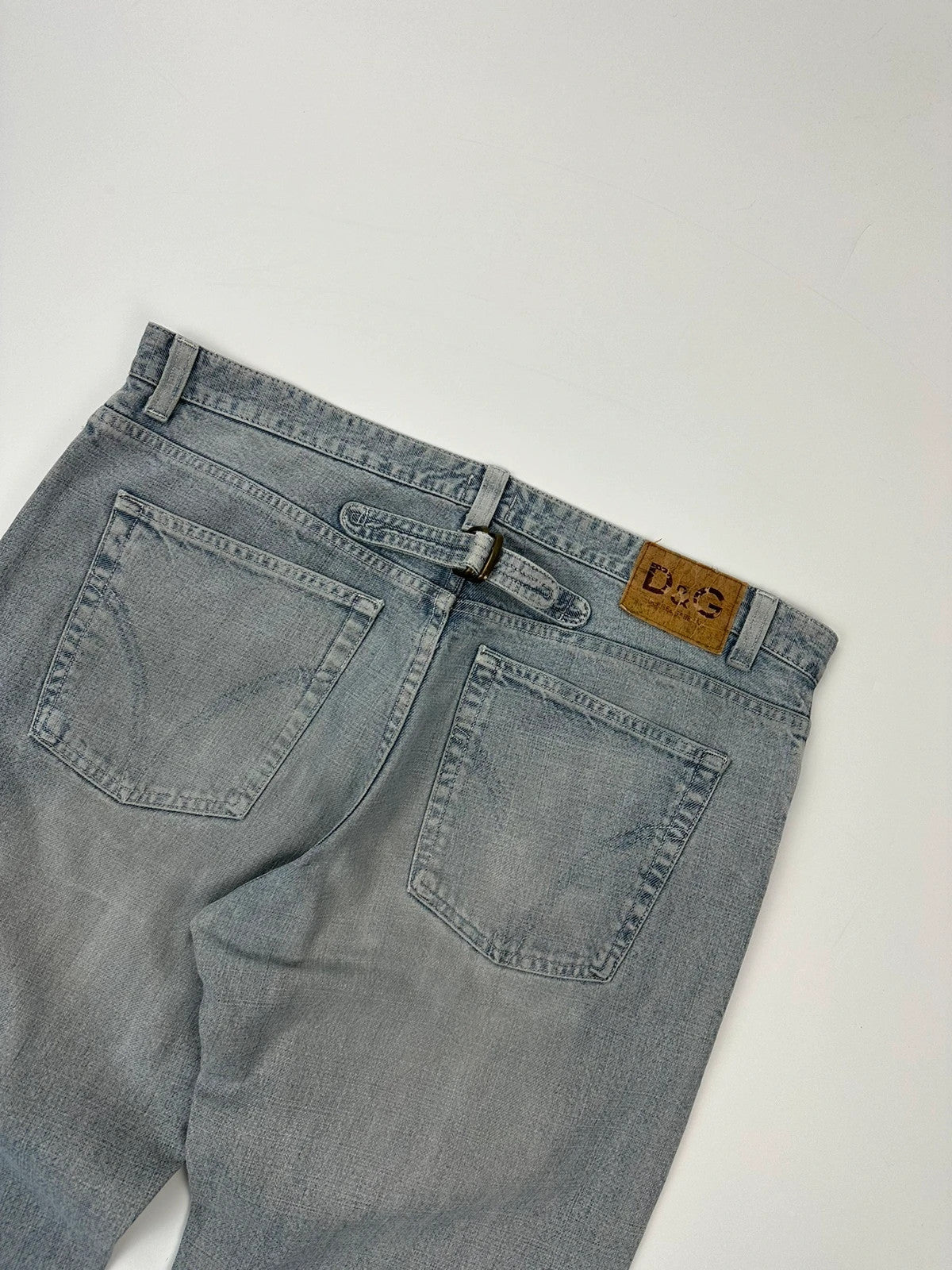 Dolce & Gabbana blue straight jeans with washed finish and back belt detail.