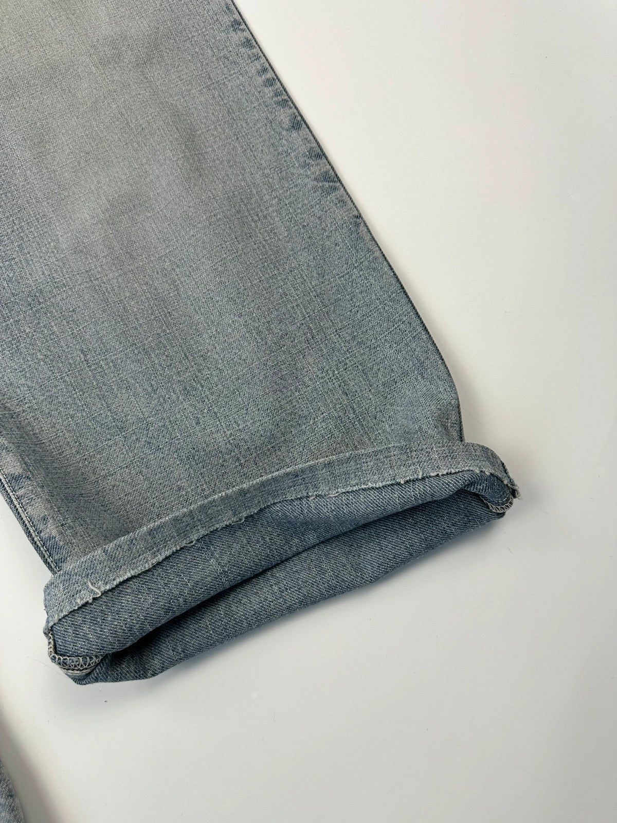 Dolce & Gabbana blue straight jeans with washed finish and back belt detail.