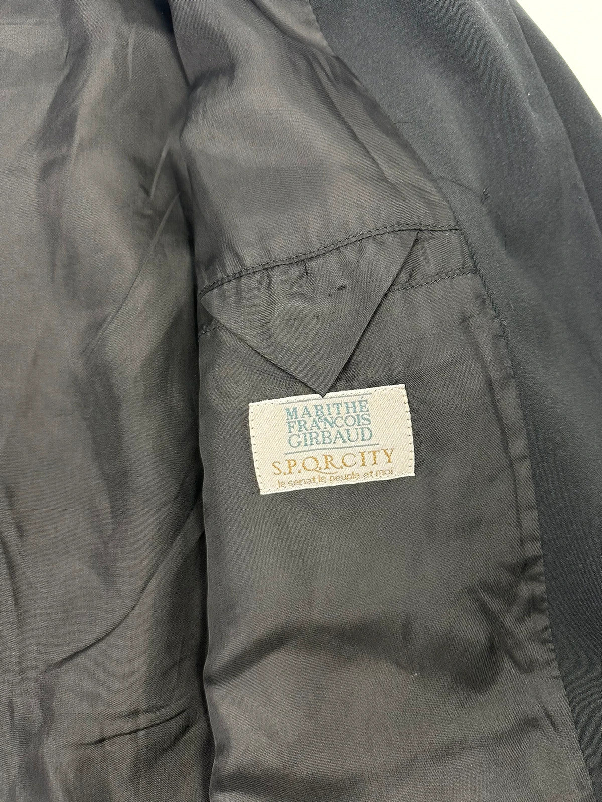 Marithé François Girbaud black jacket with adjustable shoulder pads and minimalist design.