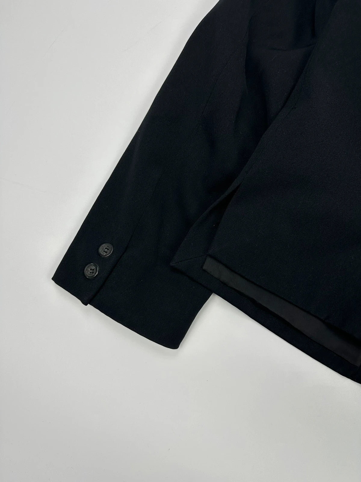 Marithé François Girbaud black jacket with adjustable shoulder pads and minimalist design.