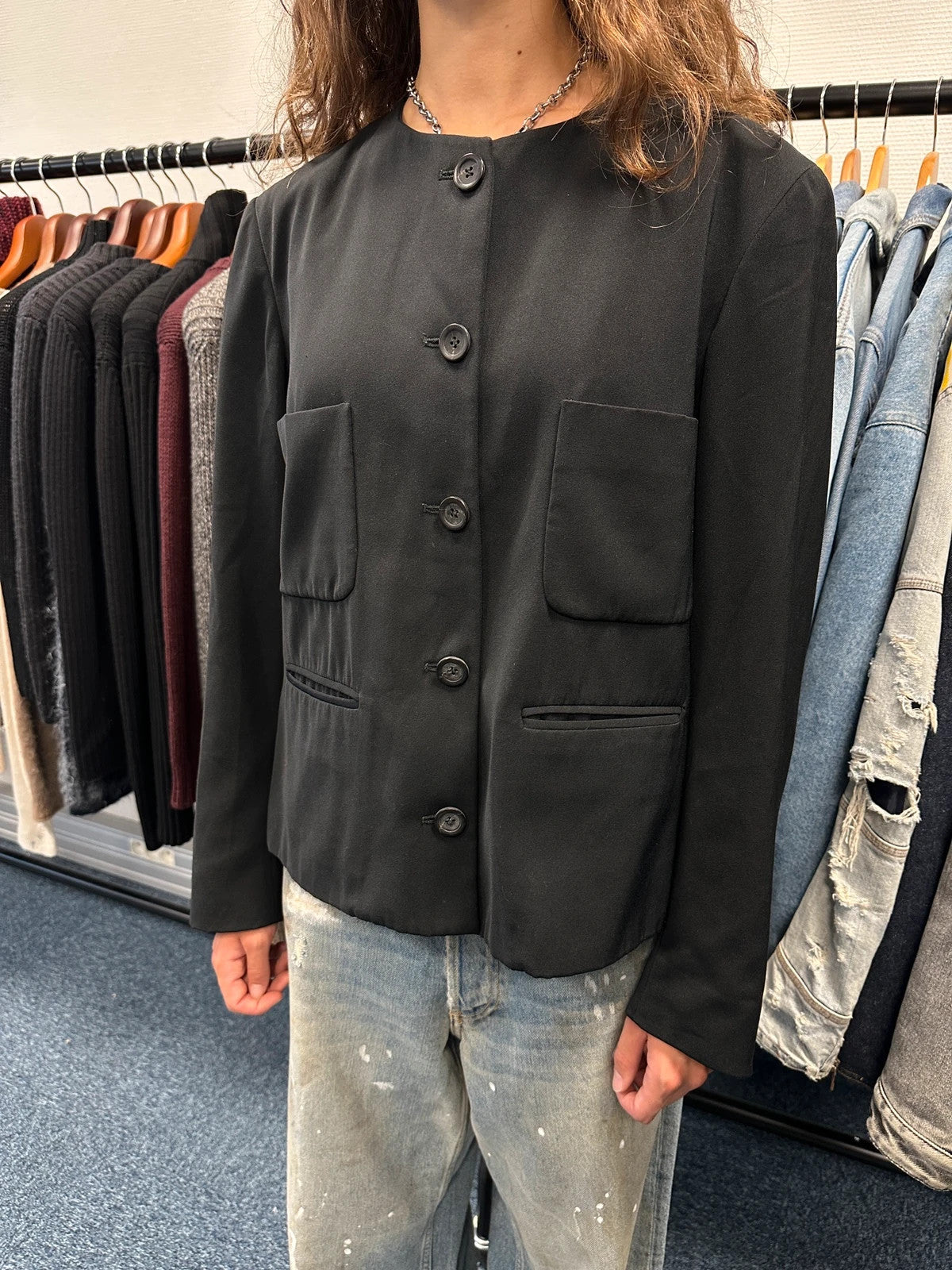 Marithé François Girbaud black jacket with adjustable shoulder pads and minimalist design.