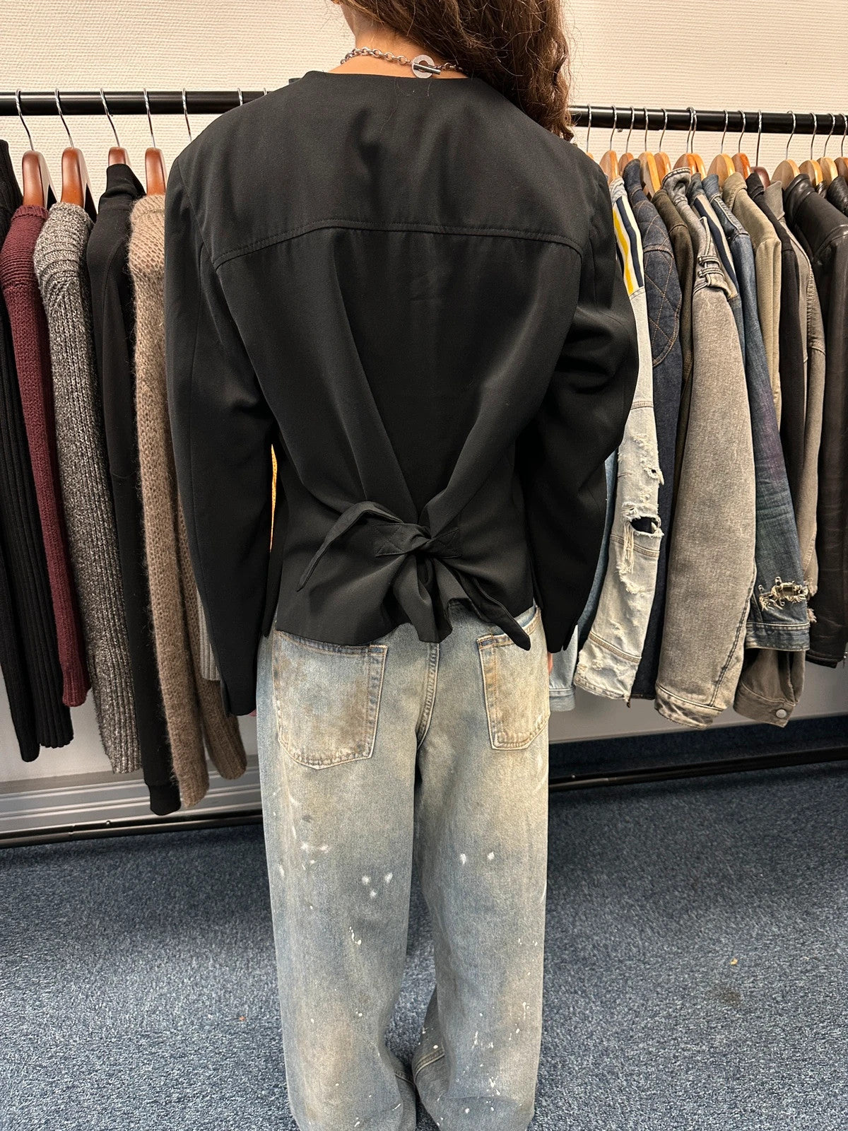 Marithé François Girbaud black jacket with adjustable shoulder pads and minimalist design.