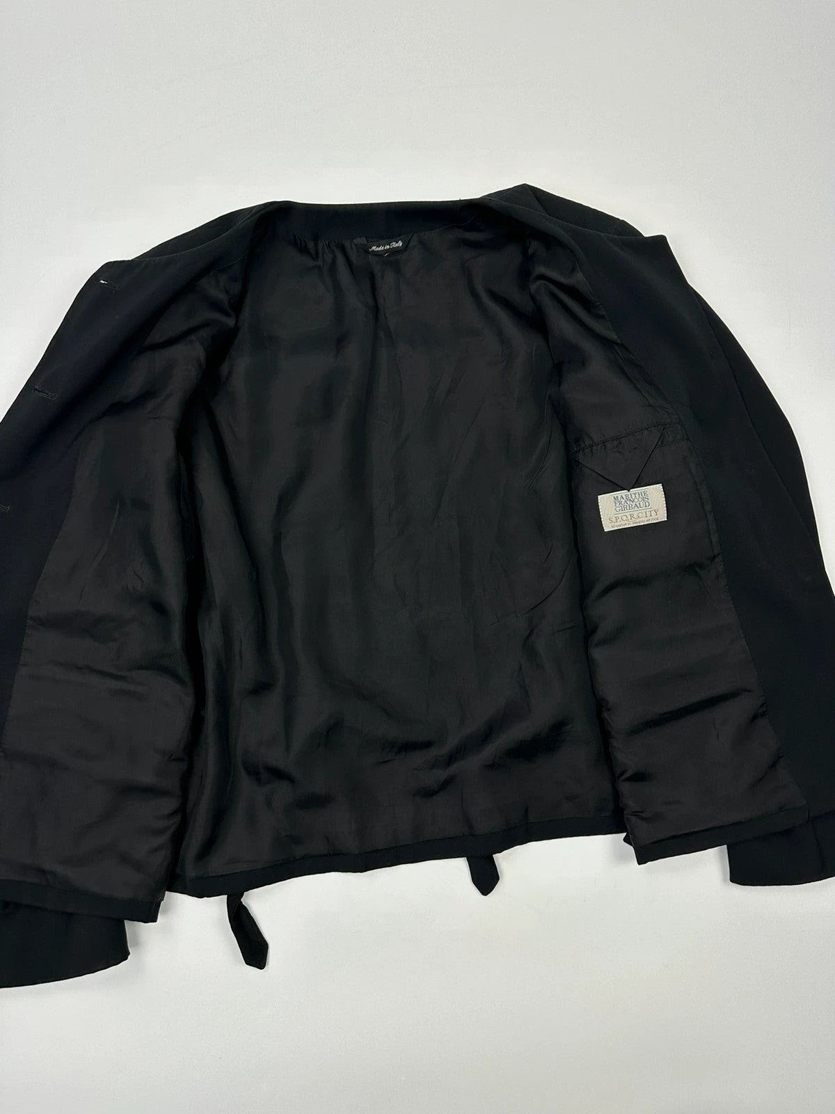 Marithé François Girbaud black jacket with adjustable shoulder pads and minimalist design.