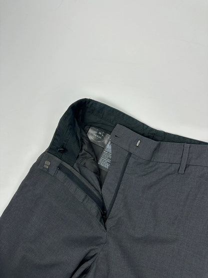Prada grey wide-leg dress pants with subtle logo detail and luxurious wool material.