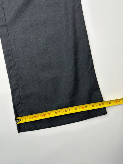 Prada grey wide-leg dress pants with subtle logo detail and luxurious wool material.