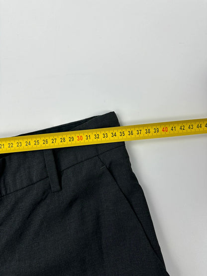 Prada grey wide-leg dress pants with subtle logo detail and luxurious wool material.
