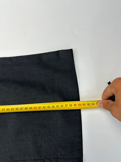 Prada grey wide-leg dress pants with subtle logo detail and luxurious wool material.