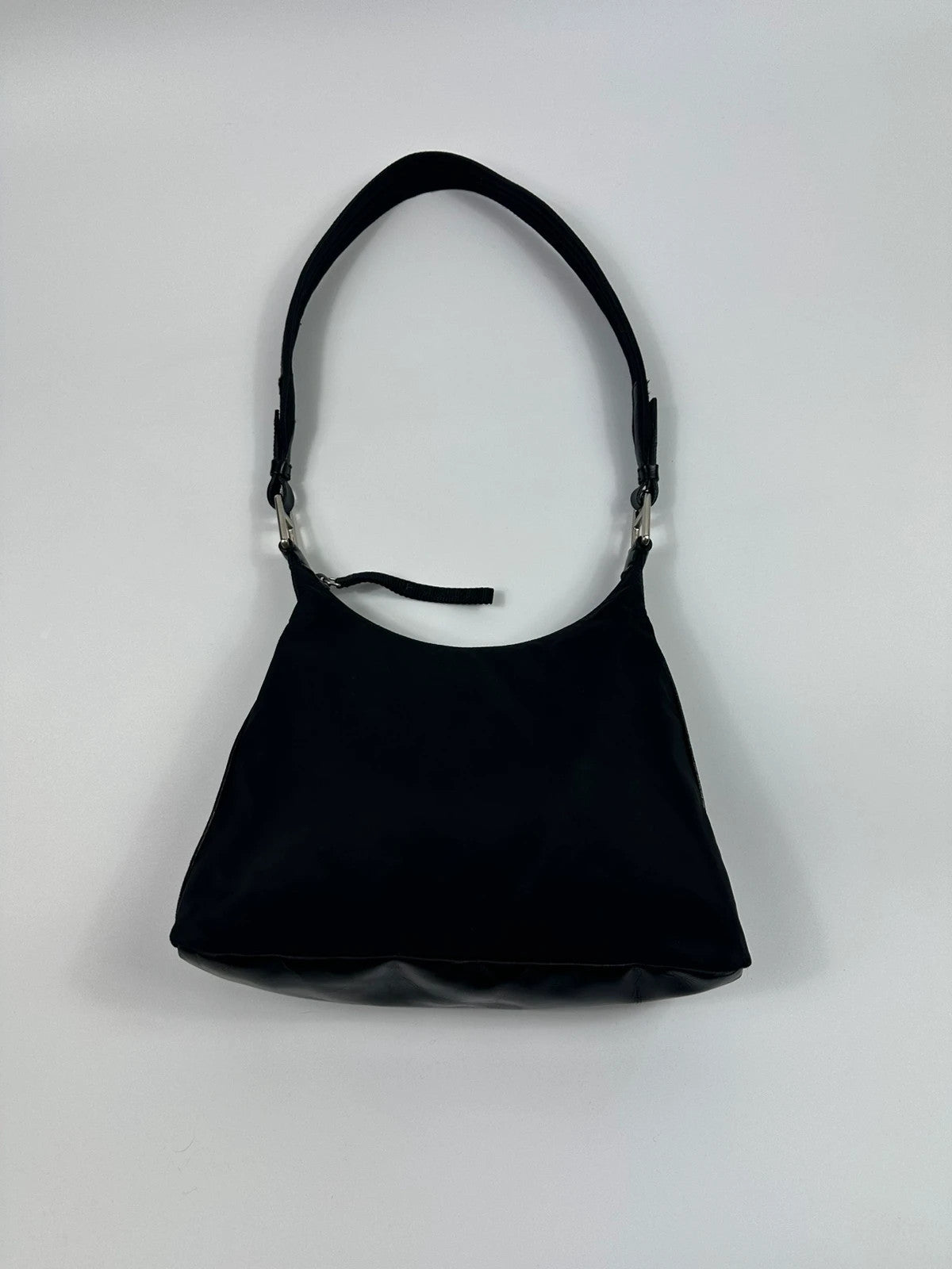 Prada black leather and nylon shoulder bag with logo detail and minimalist design.