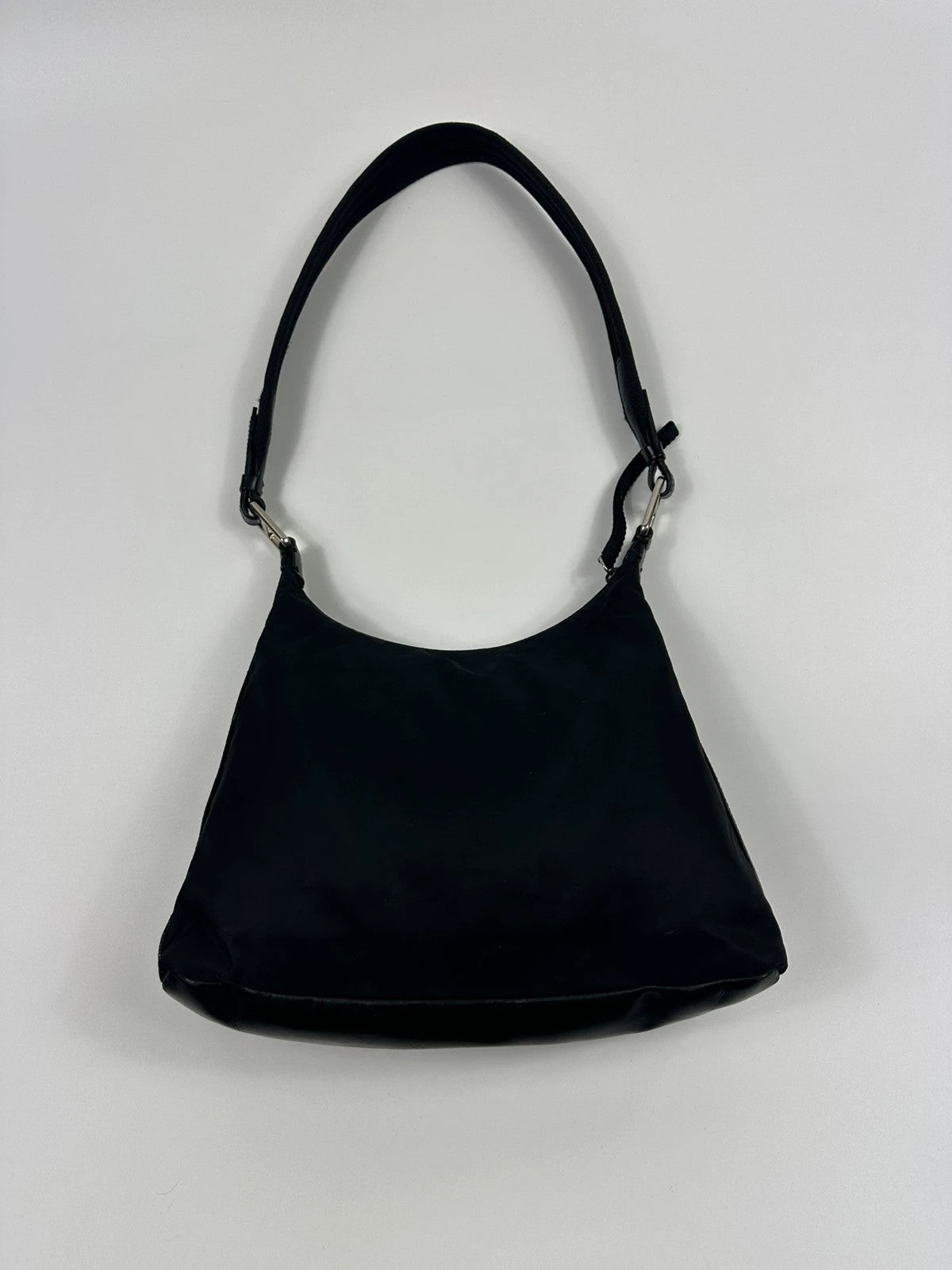 Prada black leather and nylon shoulder bag with logo detail and minimalist design.