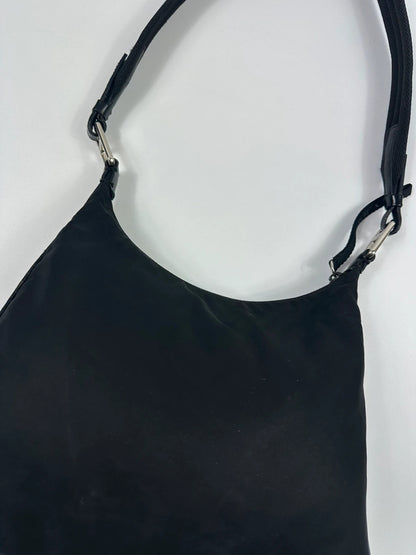 Prada black leather and nylon shoulder bag with logo detail and minimalist design.