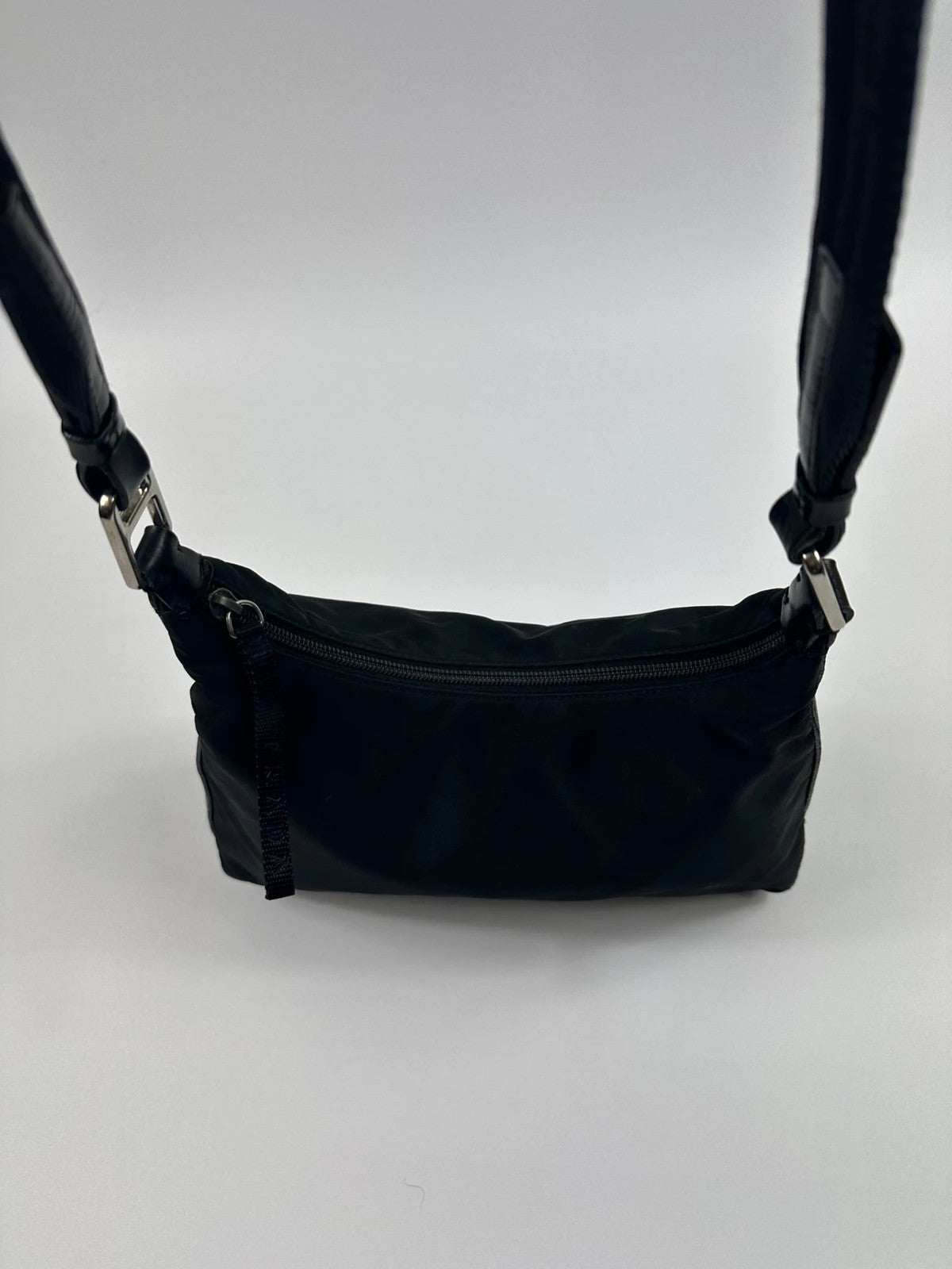 Prada black leather and nylon shoulder bag with logo detail and minimalist design.