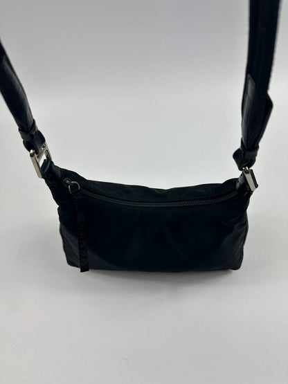 Prada black leather and nylon shoulder bag with logo detail and minimalist design.