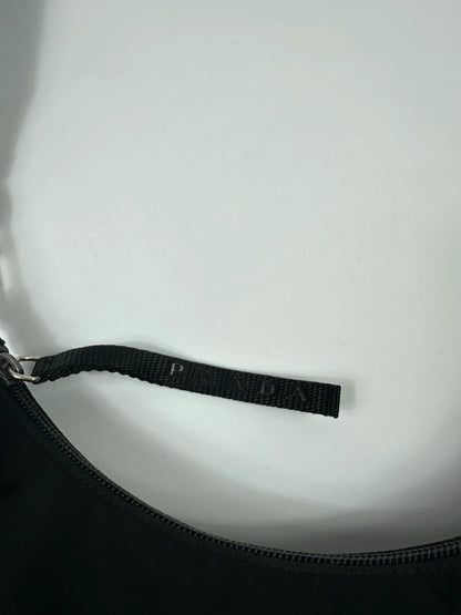 Prada black leather and nylon shoulder bag with logo detail and minimalist design.
