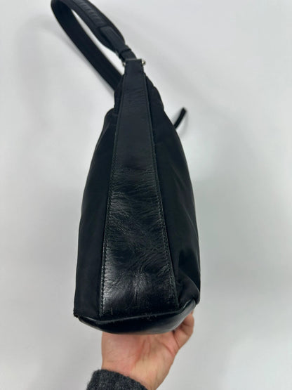 Prada black leather and nylon shoulder bag with logo detail and minimalist design.