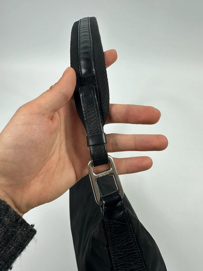 Prada black leather and nylon shoulder bag with logo detail and minimalist design.