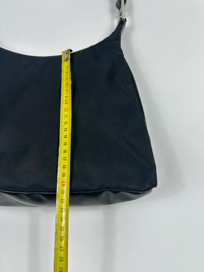 Prada black leather and nylon shoulder bag with logo detail and minimalist design.