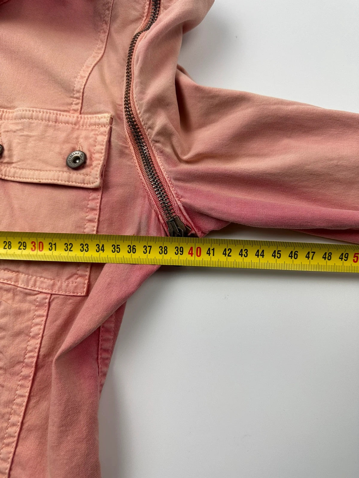 Dolce & Gabbana orange and pink denim jacket with detachable sleeves and cargo pockets.