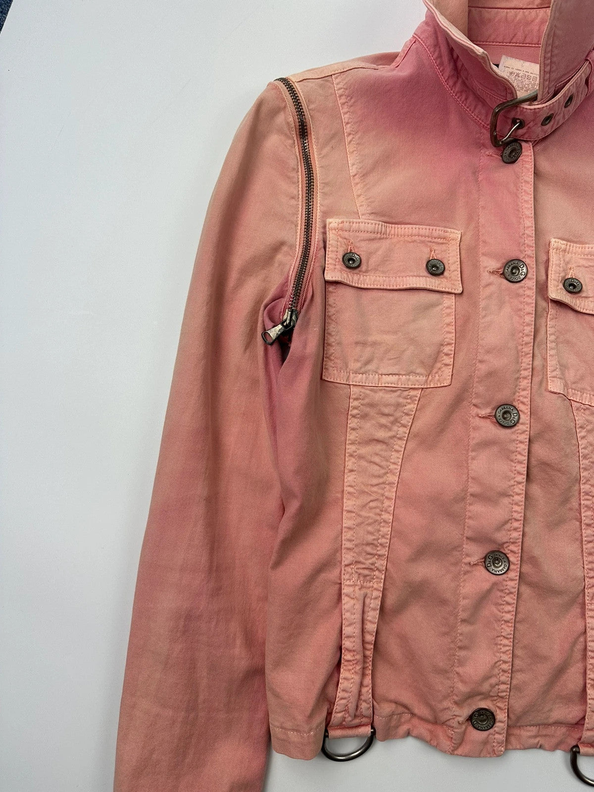 Dolce & Gabbana orange and pink denim jacket with detachable sleeves and cargo pockets.