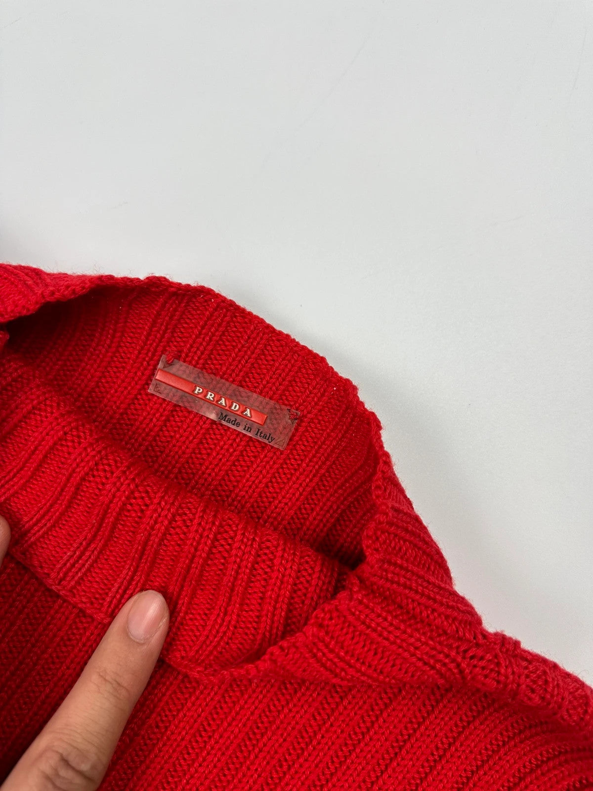 Prada red ribbed wool turtleneck sweater with high neck and Sport collection details.