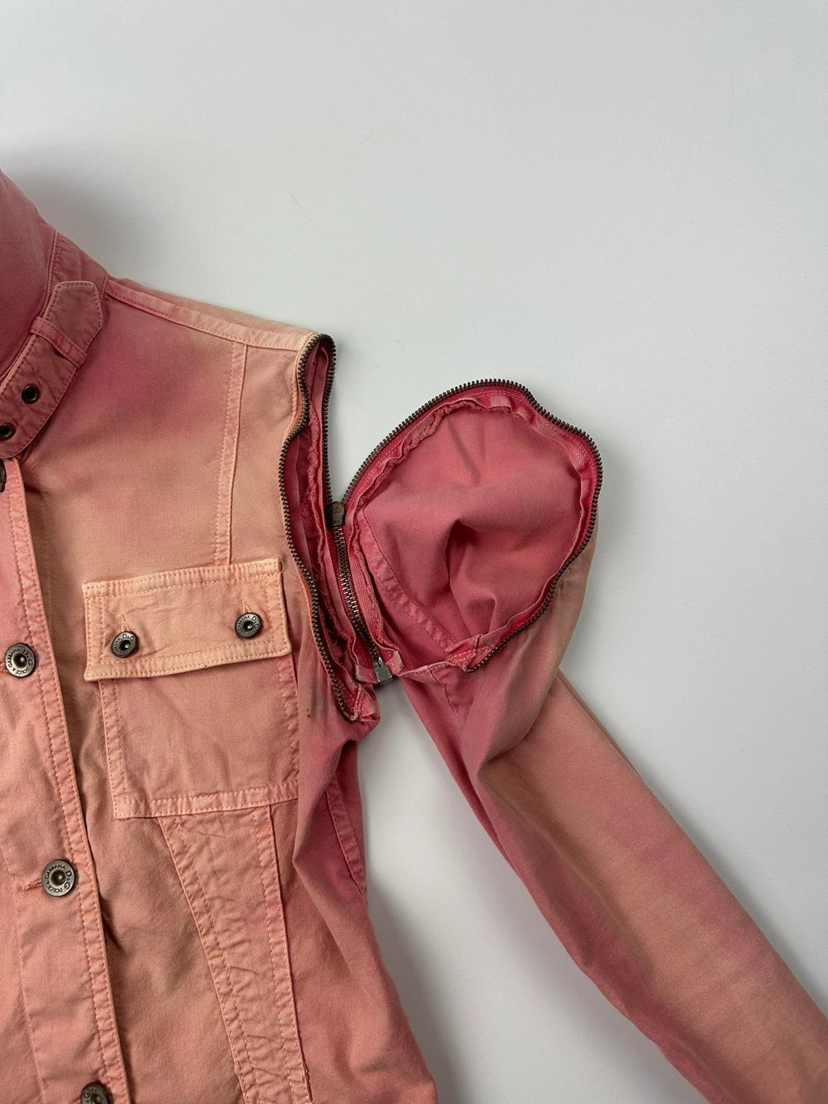 Dolce & Gabbana orange and pink denim jacket with detachable sleeves and cargo pockets.