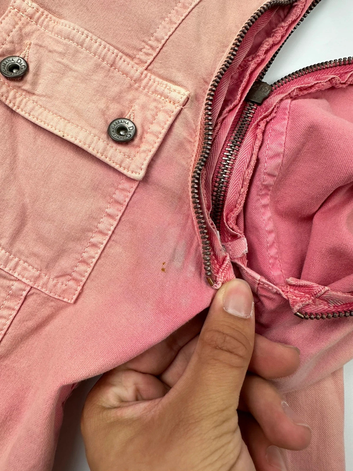 Dolce & Gabbana orange and pink denim jacket with detachable sleeves and cargo pockets.