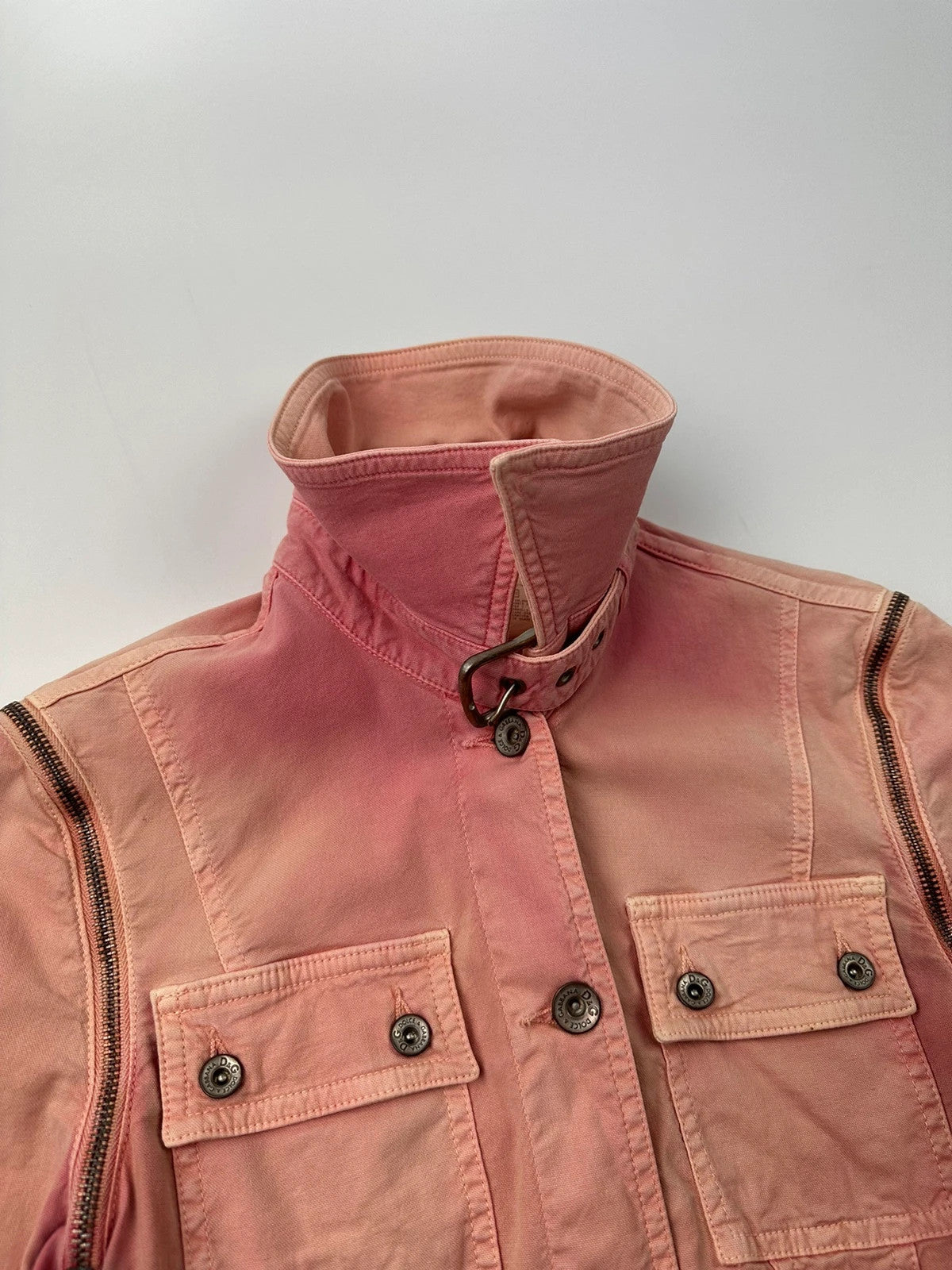 Dolce & Gabbana orange and pink denim jacket with detachable sleeves and cargo pockets.