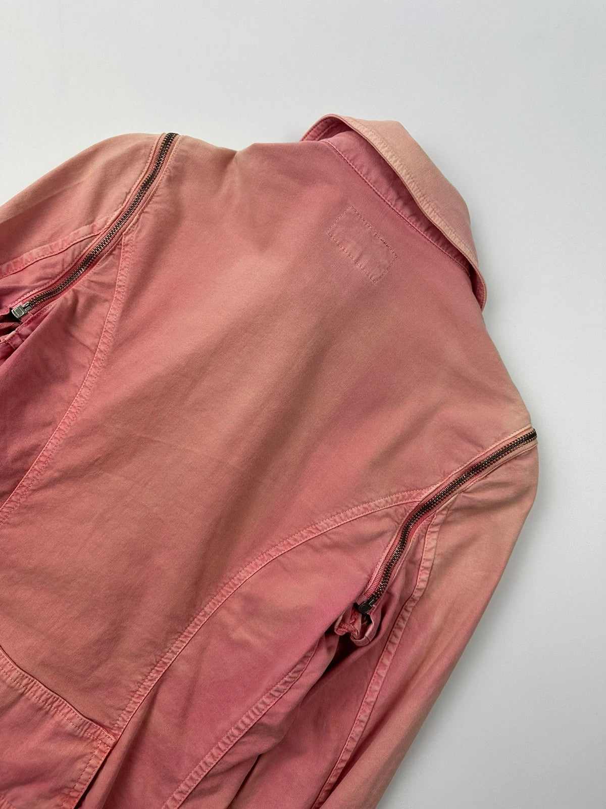 Dolce & Gabbana orange and pink denim jacket with detachable sleeves and cargo pockets.
