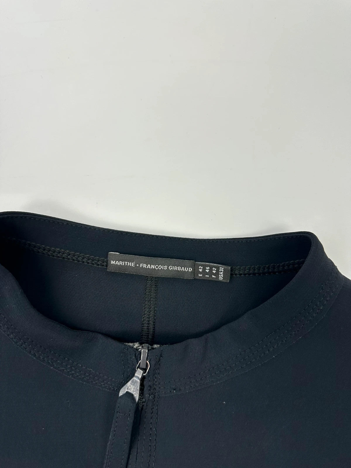 Marithé Francois Girbaud navy jacket minimalist design with subtle branding and smooth fabric.