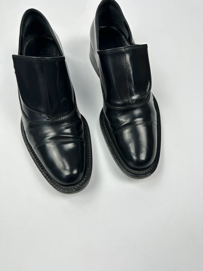 Prada black vernis loafers with pointy toe and subtle logo detailing.