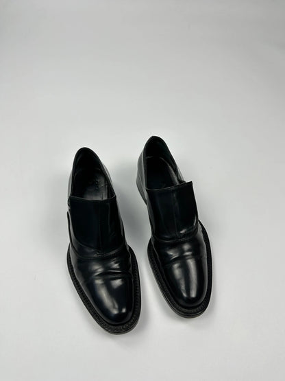 Prada black vernis loafers with pointy toe and subtle logo detailing.