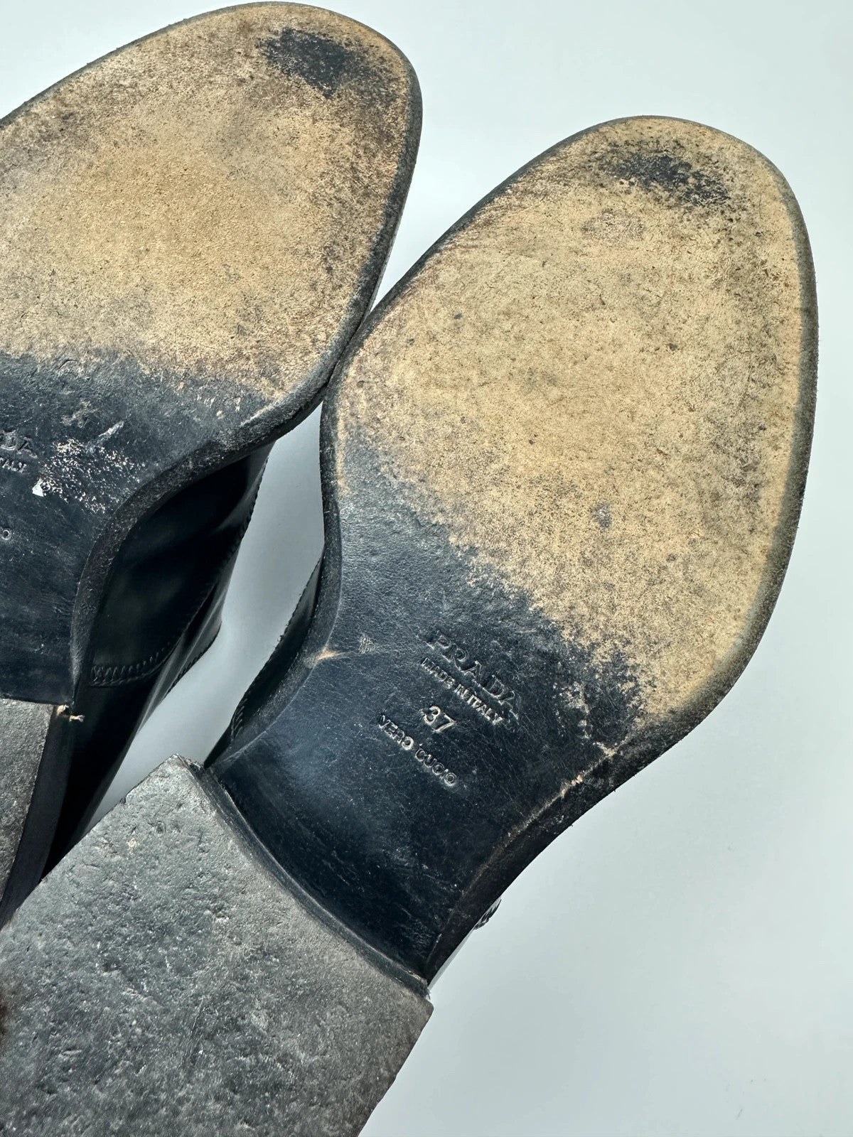 Prada black vernis loafers with pointy toe and subtle logo detailing.