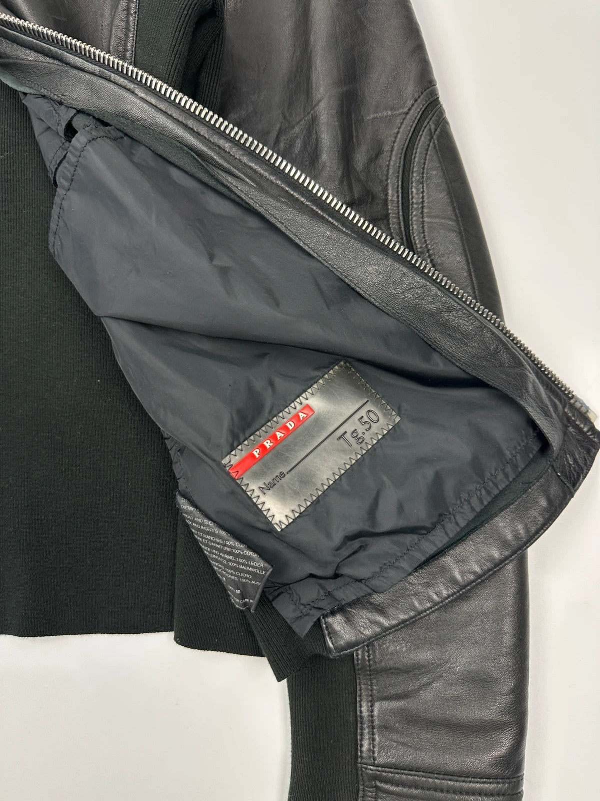 Prada black leather and cotton motor panel jacket with biker-style reinforced details.