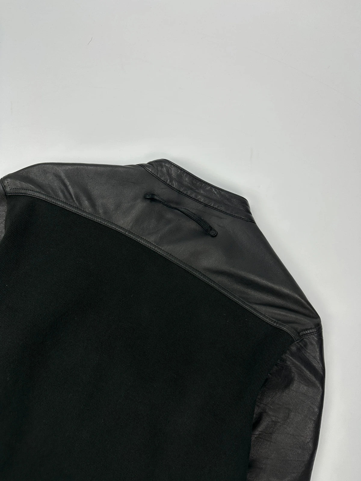 Prada black leather and cotton motor panel jacket with biker-style reinforced details.