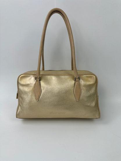 Miu Miu gold leather handbag with shiny finish and vintage 90’s design.