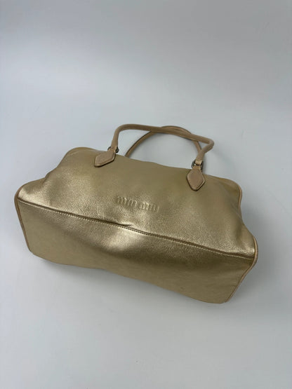 Miu Miu gold leather handbag with shiny finish and vintage 90’s design.