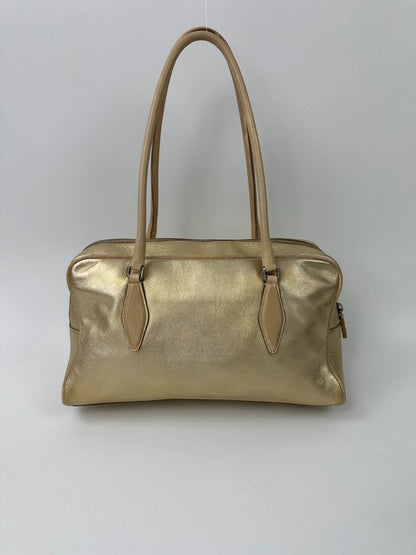 Miu Miu gold leather handbag with shiny finish and vintage 90’s design.