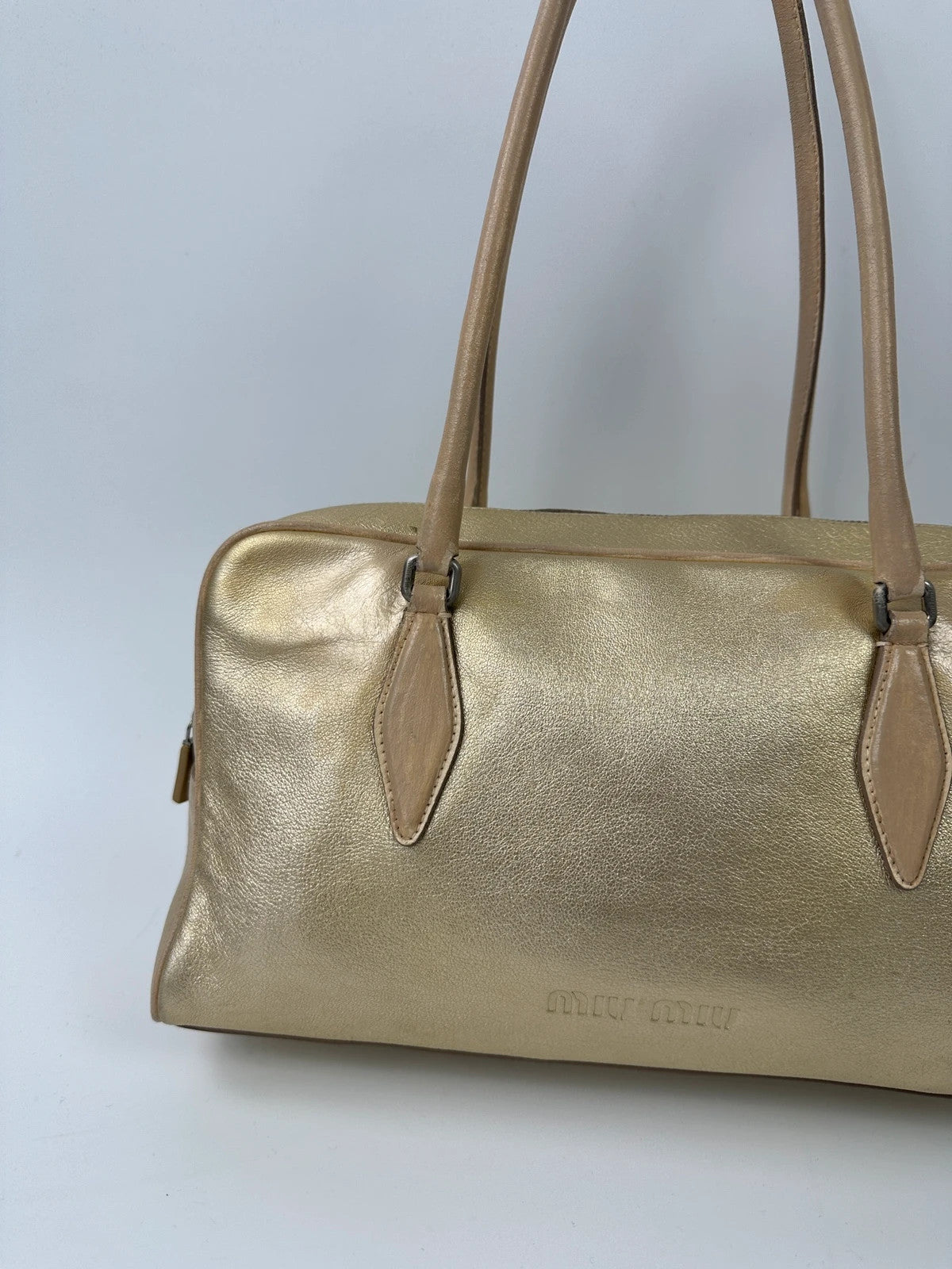 Miu Miu gold leather handbag with shiny finish and vintage 90’s design.