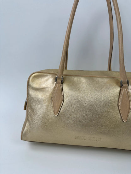 Miu Miu gold leather handbag with shiny finish and vintage 90’s design.