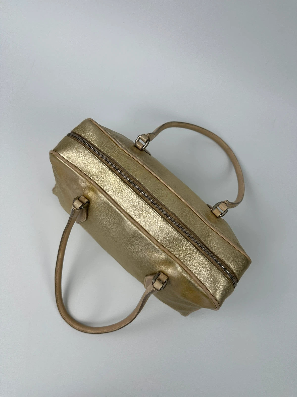 Miu Miu gold leather handbag with shiny finish and vintage 90’s design.