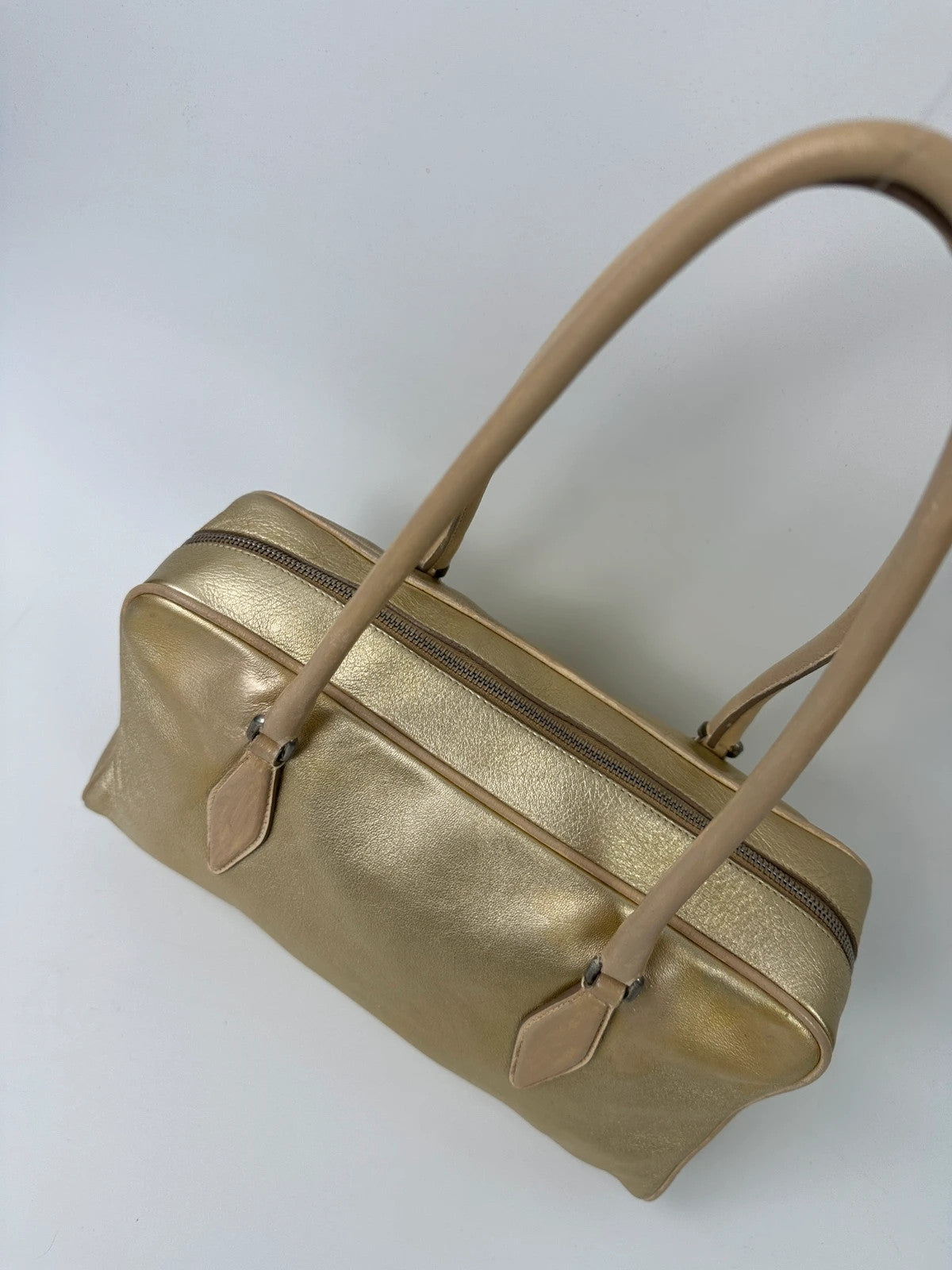 Miu Miu gold leather handbag with shiny finish and vintage 90’s design.