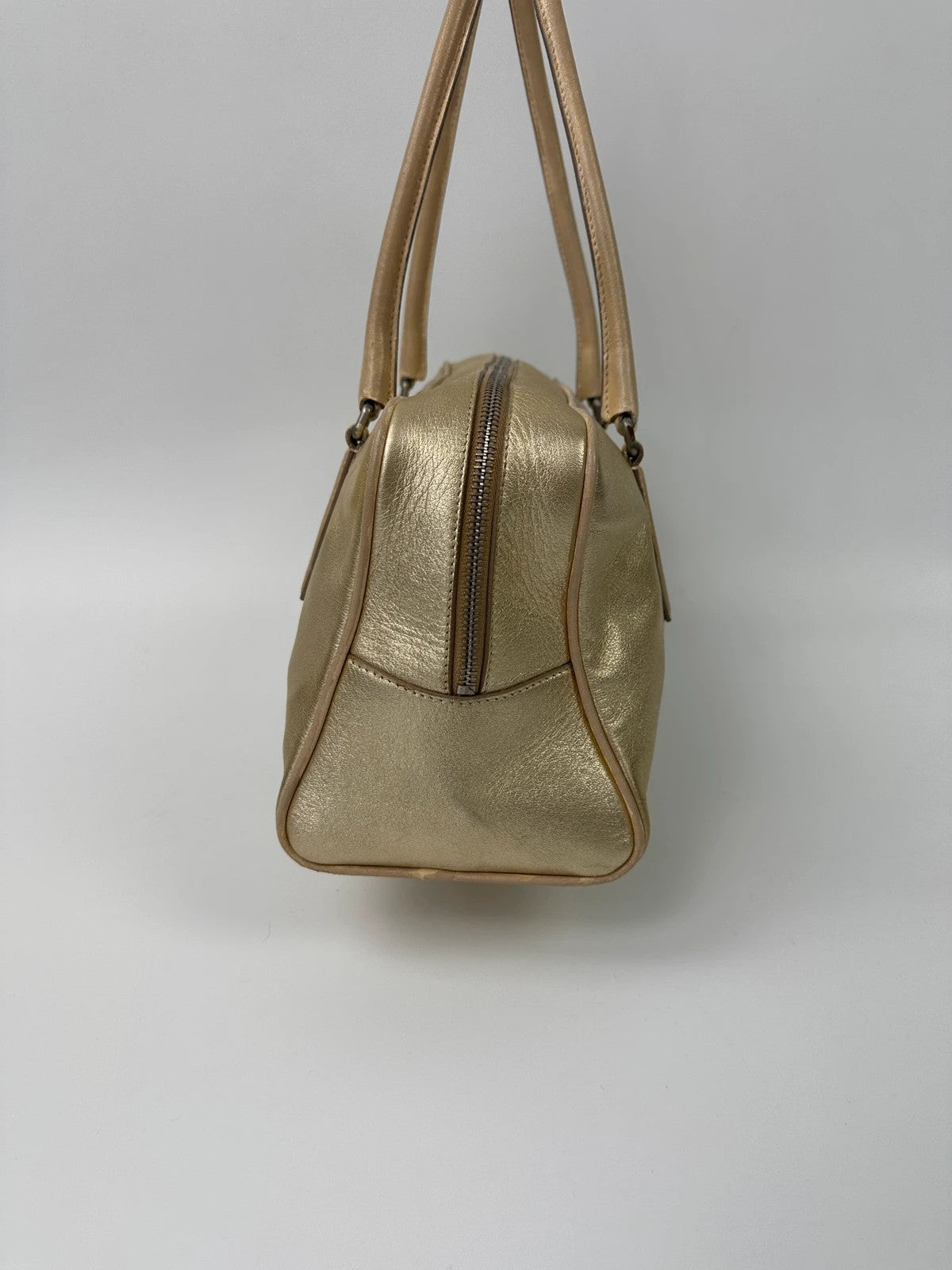 Miu Miu gold leather handbag with shiny finish and vintage 90’s design.