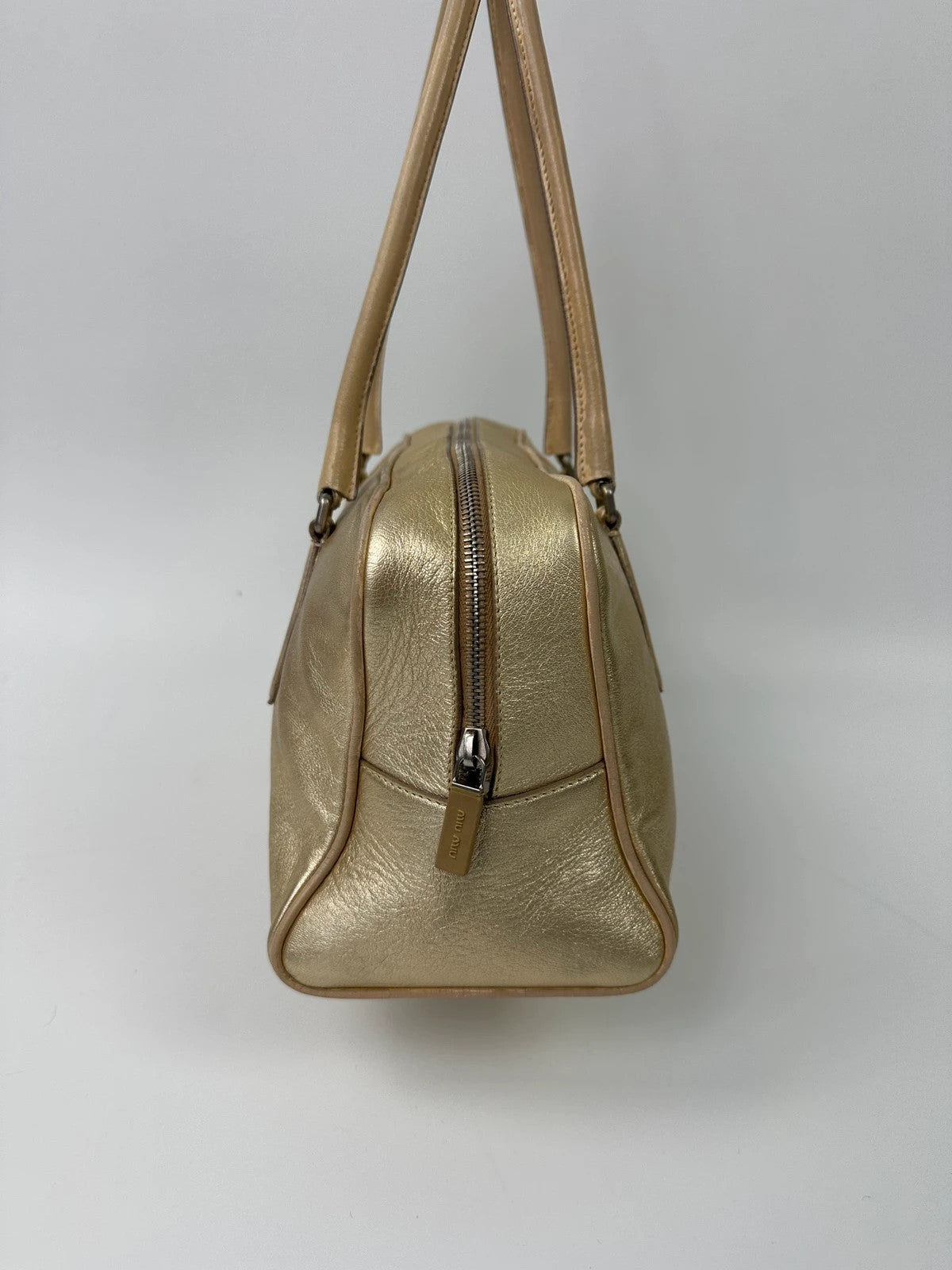 Miu Miu gold leather handbag with shiny finish and vintage 90’s design.