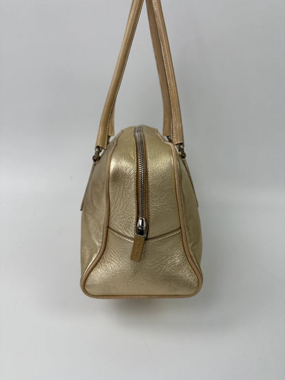Miu Miu gold leather handbag with shiny finish and vintage 90’s design.