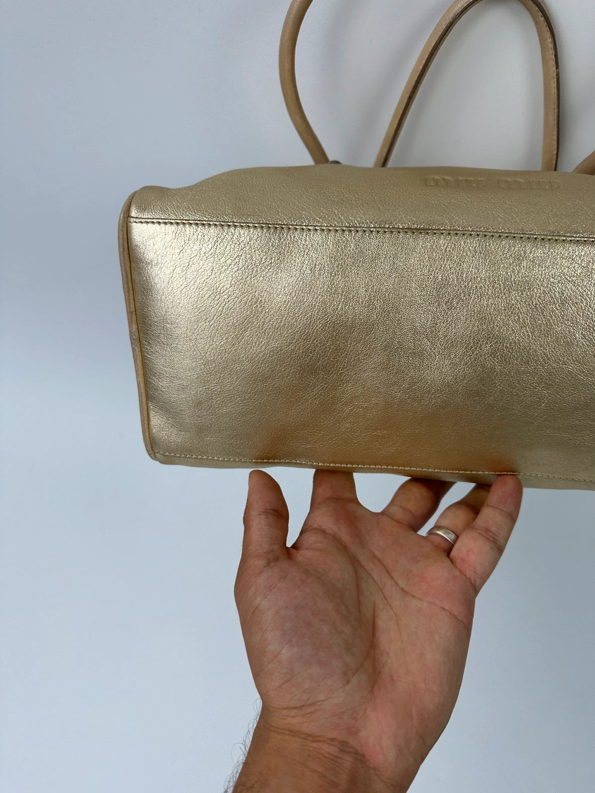 Miu Miu gold leather handbag with shiny finish and vintage 90’s design.